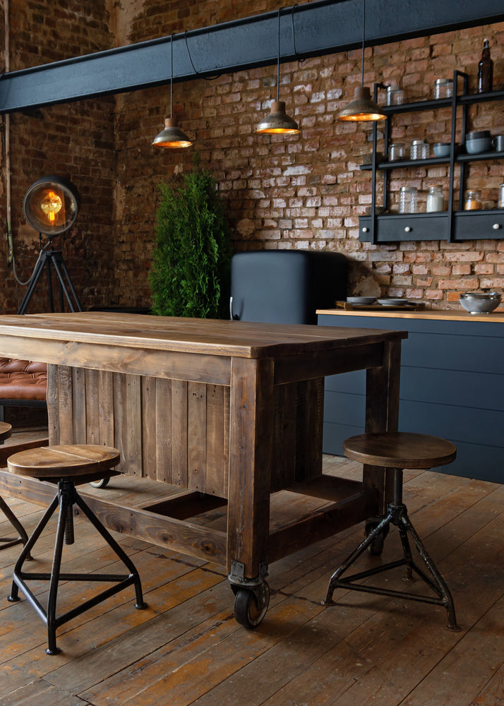 Industrial style kitchen.  Black Pendant lights, exposed brick, steel beam, and wood island.